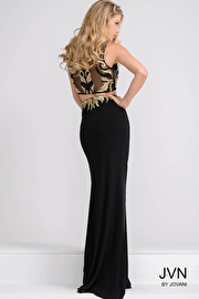 Black two piece beaded top with sheer neckline and jersey skirt prom dress.